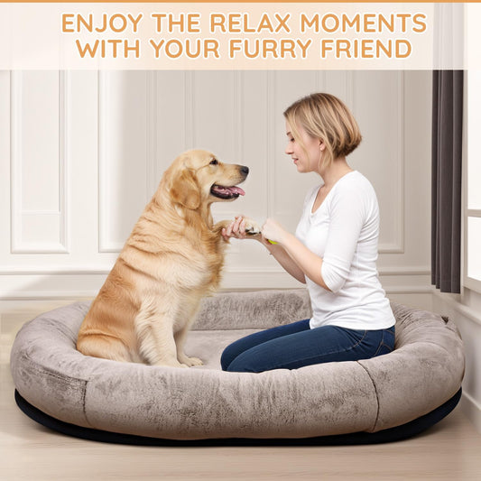 dog and owner lounging together on a giant human-sized dog bed